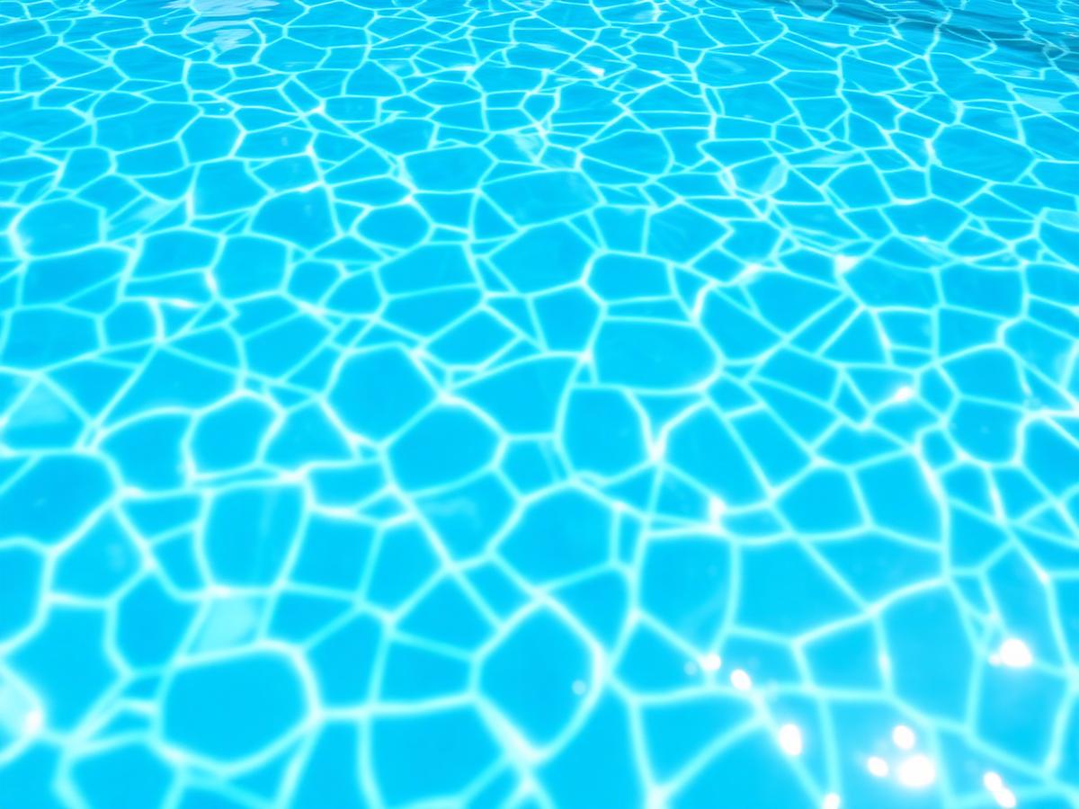 Sunlit pool tile and clear water after a weekly service visit